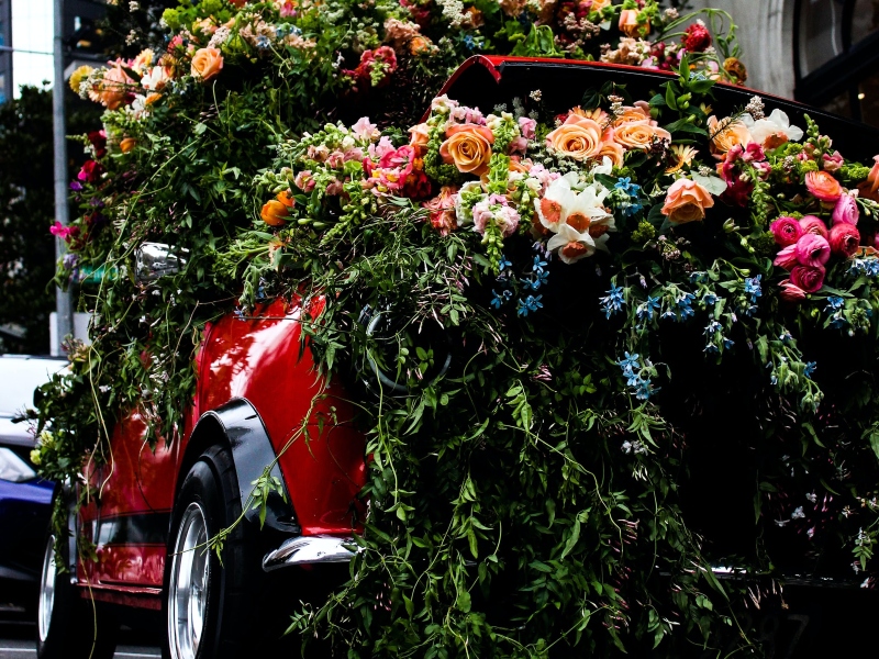 Groom’s car heavily decorated with flowers